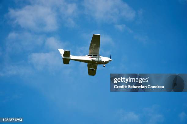 small airplane isolated on blue, near the cluj-napoca. transylvania, romania. - small airplane stock pictures, royalty-free photos & images