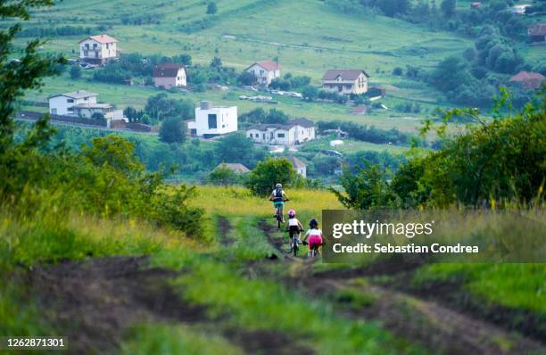 mother and daughters recreating cycling on the hills. - cluj napoca imagens e fotografias de stock