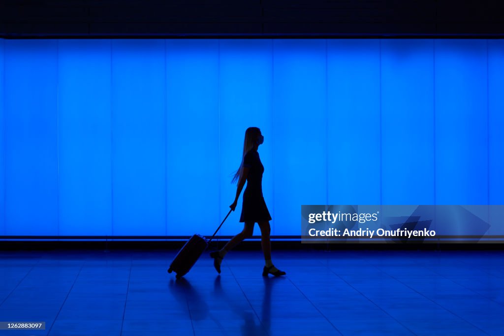 Silhouette of walking young woman