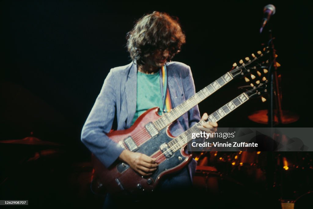 English musician Jimmy Page performs on his double-neck Gibson guitar ...