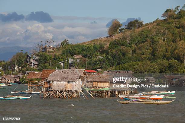 stilt houses sit above the water - philippine tribesmen stock pictures, royalty-free photos & images