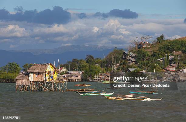 stilt houses sit above the water - philippine tribesmen stock pictures, royalty-free photos & images