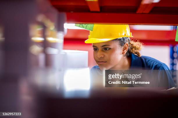 female warehouse worker searching, examining stock goods in a distribution warehouse. warehouse management. - differential focus stock pictures, royalty-free photos & images