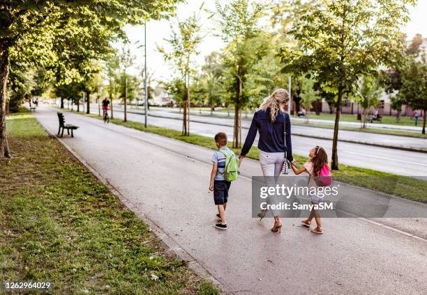 portrait of a mother taking her children to school - school district stock pictures, royalty-free photos & images