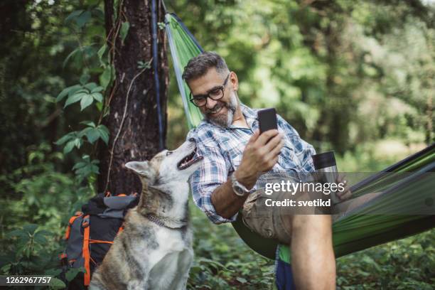 die natur genießen - middle age man with dog stock-fotos und bilder