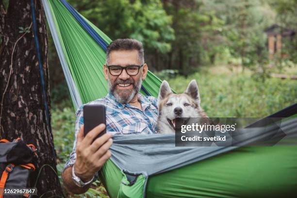 enjoying nature - hammock phone stock pictures, royalty-free photos & images