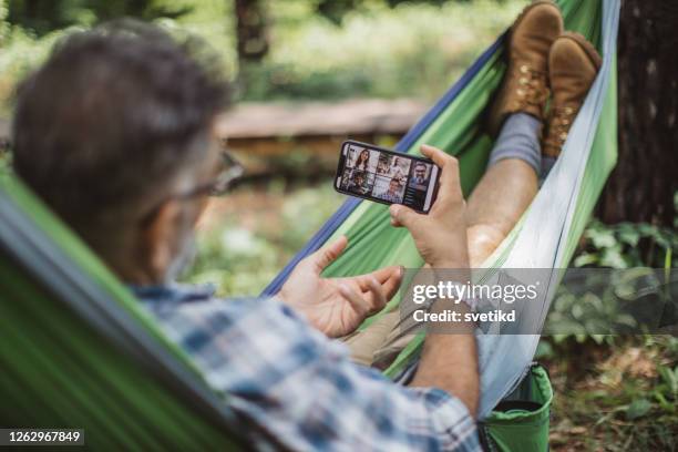 forest office for the day - smartphones dangling stock pictures, royalty-free photos & images