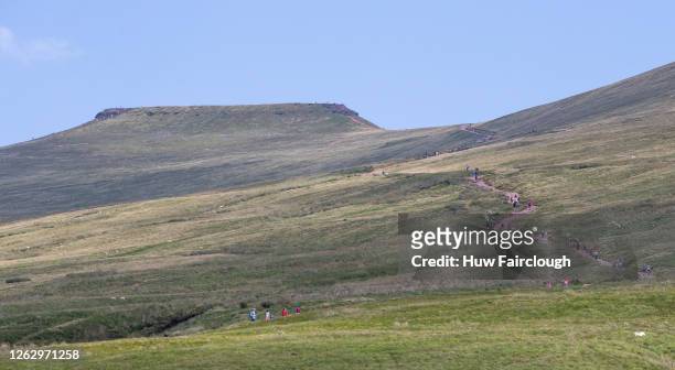 General view of members of the public walking Pen y Fan, South Wales highest mountain on July 31, 2020 in Brecon, United Kingdom. High temperatures...