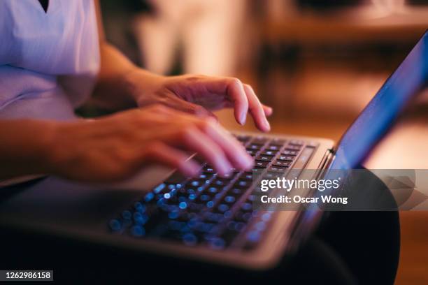 close-up shot of female hands typing on laptop keyboard, working late at home - arabic keyboard fotografías e imágenes de stock