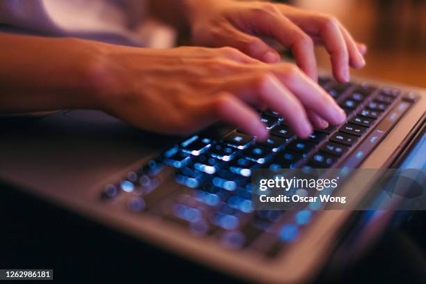 close-up shot of female hands typing on laptop keyboard, working late at home - arabic keyboard fotografías e imágenes de stock