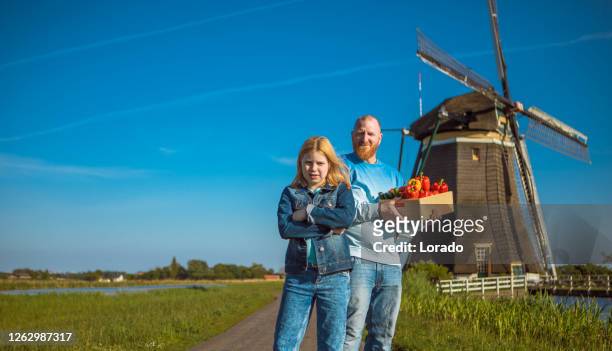 a dutch farmer and his family at a windmill - dutch windmill stock pictures, royalty-free photos & images