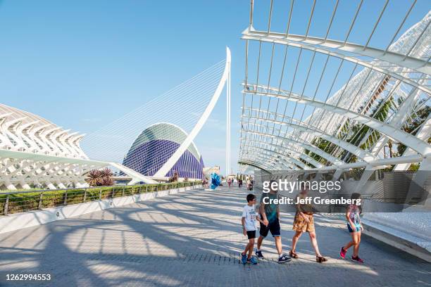 Spain, Valencia, City of Arts and Sciences, Prince Philip Science Museum, L'Umbracle, Assut de l'Or Bridge, L'Agora, family on promenade.