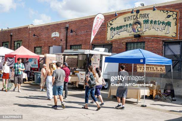 Florida, Orlando, Farmers' Market, busy vendor stands.