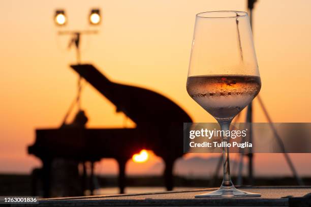 General view of a glass of wine is taken during a Concert in the Albaria Pellegrino Sea Theatre at Salina Genna on July 30, 2020 in Marsala, Italy....