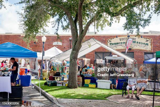 Florida, Orlando, Farmers' Market, vendors around shade tree.