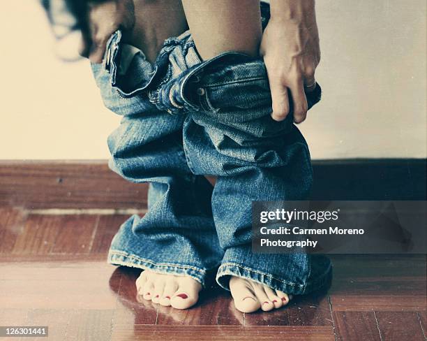 woman taking off jeans - removing pants stock pictures, royalty-free photos & images