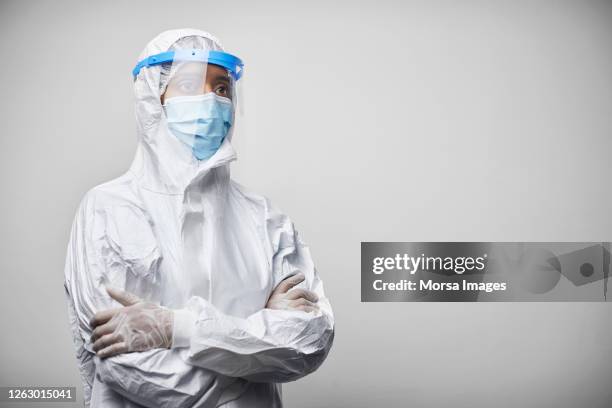 portrait of mixed race doctor/nurse in protective workwear - face shield ストックフォトと画像