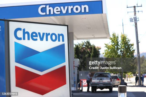 Customer pumps gas into his truck at a Chevron gas station on July 31, 2020 in Novato, California. Chevron Corp reported a $8.27 billion loss in...