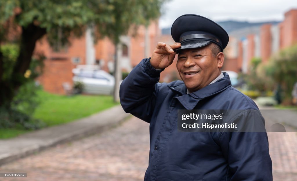 Happy security guard working at a gated neighborhood