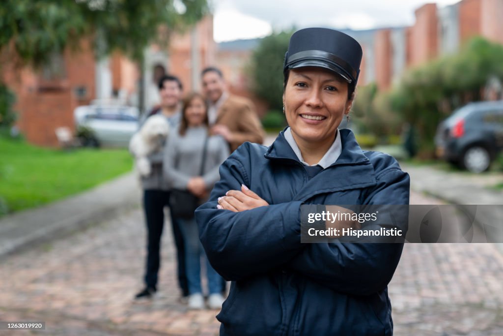 Happy security guard working at a gated community protecting people