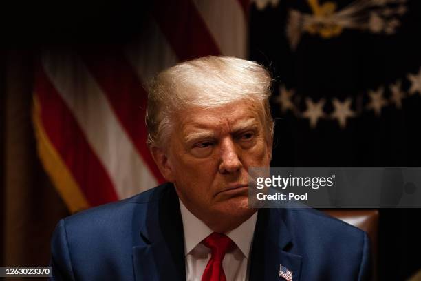 President Donald Trump listens during a meeting with members of the National Association of Police Organizations Leadership in the Cabinet Room of...