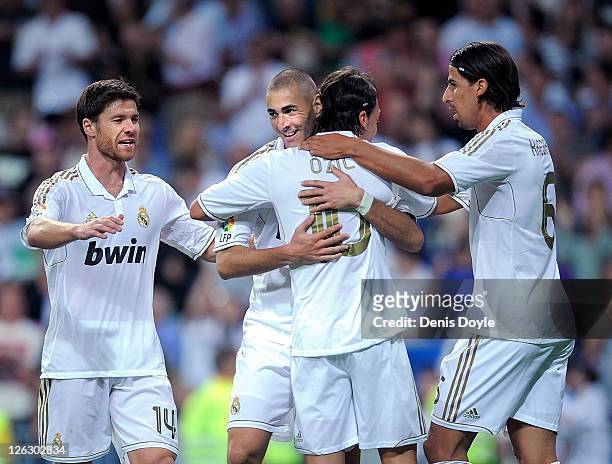 Karim Benzema of Real Madrid celebrates with Mesut Ozil after scoring Real's 6th goal during the La Liga match between Real Madrid and Rayo Vallecano...