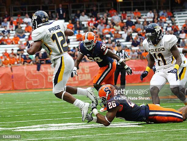 Kevyn Scott of the Syracuse Orange catches the toes of Eric Page of the Toledo Rockets in the game on September 24, 2011 at the Carrier Dome in...