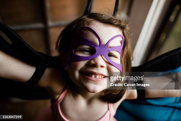 close up of young girl in dress up smiling for camera - blumenkrone stock-fotos und bilder