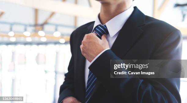 businessman  adjusting his neck tie. - school tie stock pictures, royalty-free photos & images