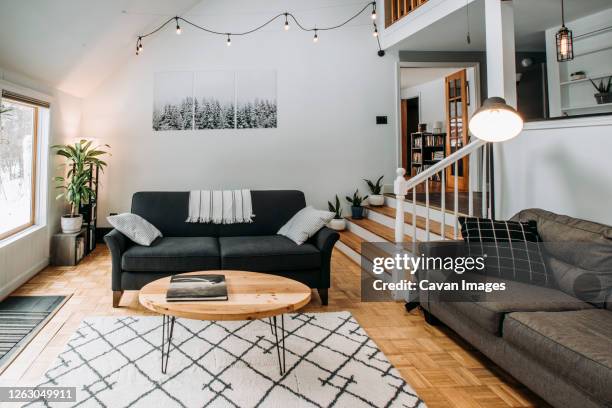 modern scandinavian living room interior with couch and lighting - couchtisch stock-fotos und bilder
