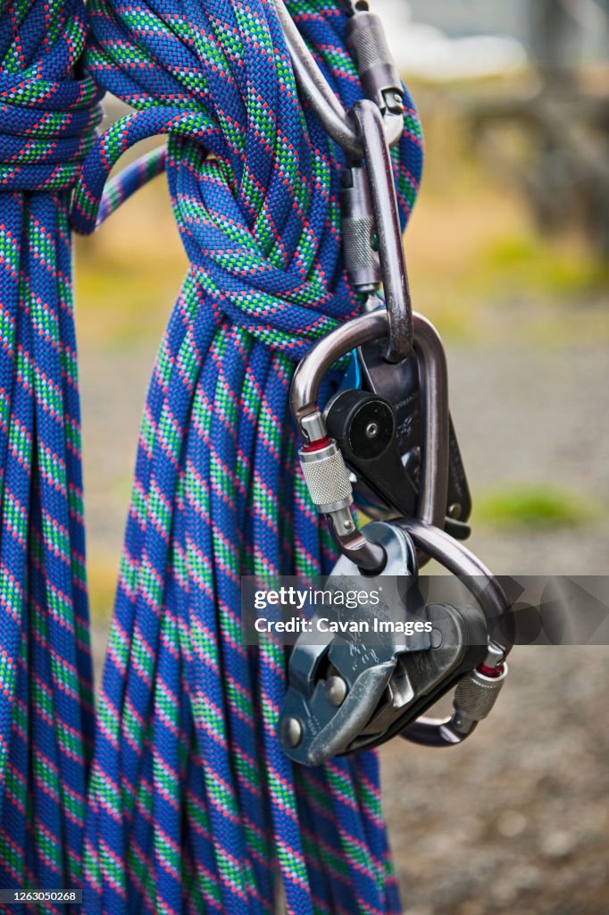 Close up shot of climbing rope and belay device