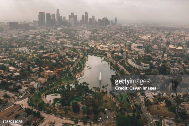 echo park in los angeles with view of downtown skyline and foggy polluted smog air in big urban city - silver lake fotografías e imágenes de stock