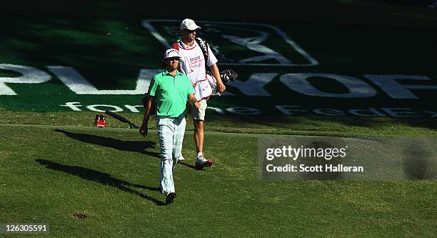 Aaron Baddeley of Australia walks with his caddie Anthony Knight to the 18th green during the third round of the TOUR Championship at East Lake Golf...