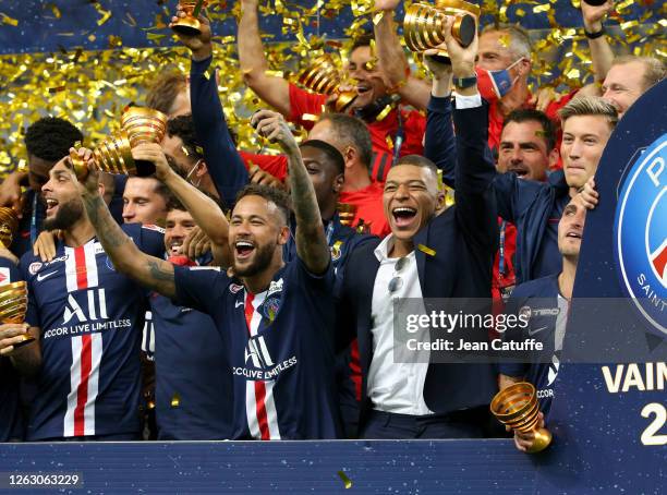 Neymar Jr, Kylian Mbappe of PSG and teammates celebrate the victory during the trophy ceremony following the French League Cup final between Paris...