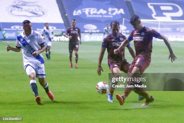 Cristian Menedez of Puebla fights for the ball with Igor Lichnovsky of Cruz Azul during the 2nd round match between Puebla FC and Cruz Azul as part...