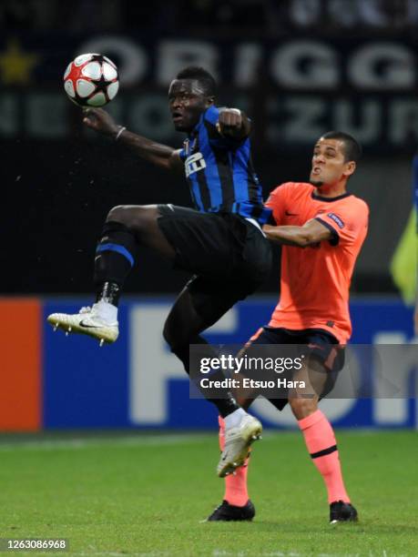 Sulley Muntari of Inter Milan controls the ball under pressure of Dani Alves of Barcelona in action during the UEFA Champions League Group F match...