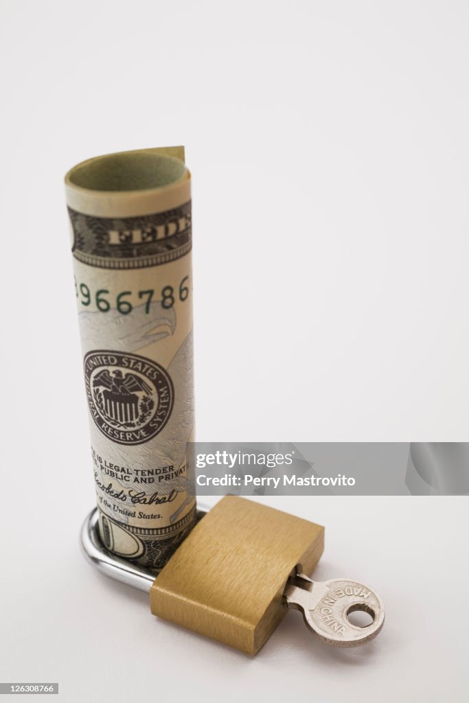 Brass Lock around a US bank note