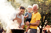 Family on vacation having barbecue party