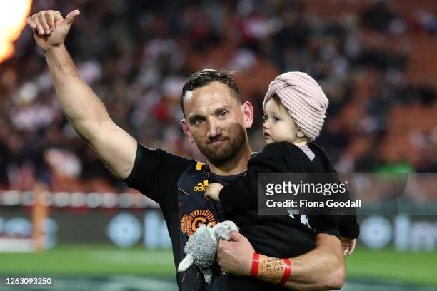 Aaron Cruden of the Chiefs runs out with his baby daughter for his 100th match for the Chiefs during the round eight Super Rugby Aotearoa match...