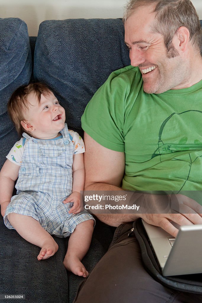 Dad & baby laughing on sofa