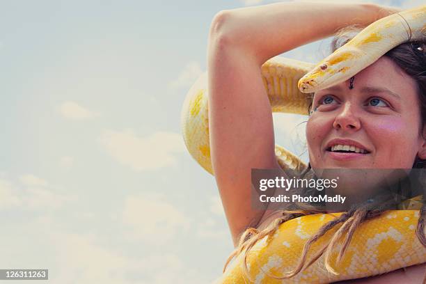 woman holding yellow snake - morelia stock pictures, royalty-free photos & images