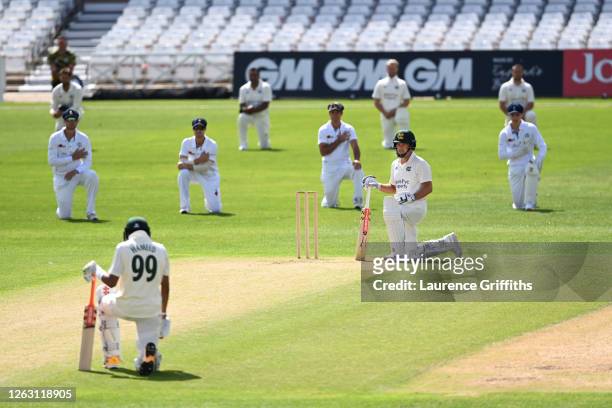 Nottinghamshire opening batsmen Chris Nash and Haseeb Hameed take the knee in support of "Black Lives Matter" along with the Derbyshire team at Trent...