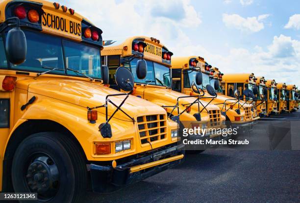 school buses in a row - school bus stock photos et images de collection