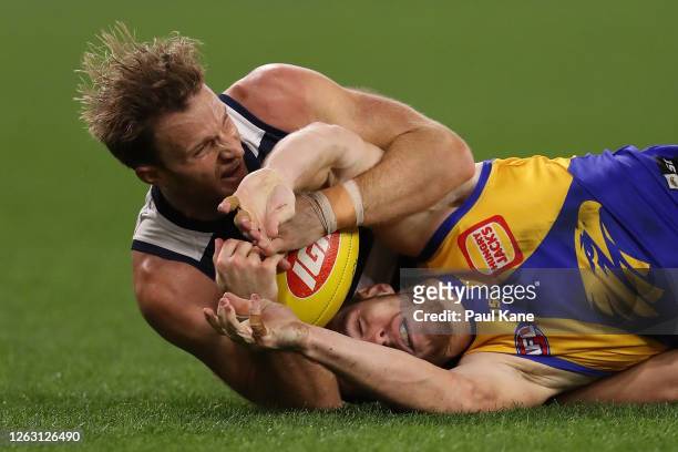 Lachie Henderson of the Cats tackles Luke Shuey of the Eagles during the round nine AFL match between West Coast Eagles and the Geelong Cats at Optus...