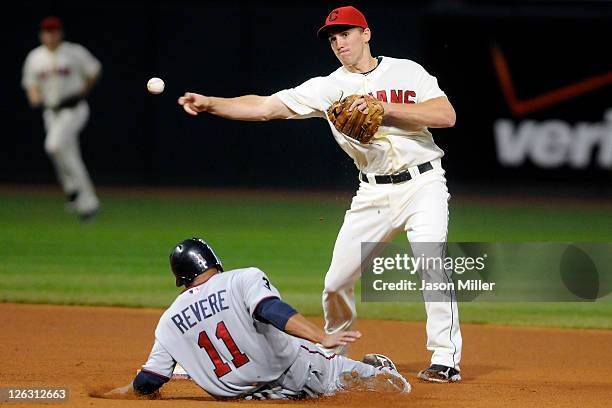 Ben Revere of the Minnesota Twins is out at second as Cord Phelps of the Cleveland Indians throws to first during the fourth inning at Progressive...