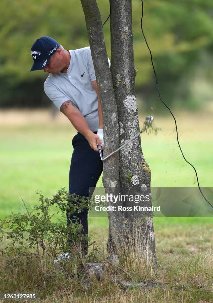 Callum Shinkwin of England brakes his club whilst playing his second shot behind a tree on the third hole during Day three of the Hero Open at...