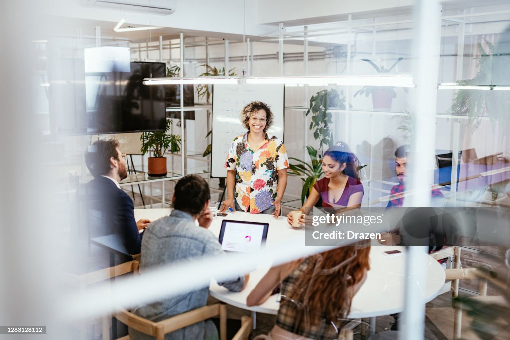 Business people sitting in board room and keep social distance