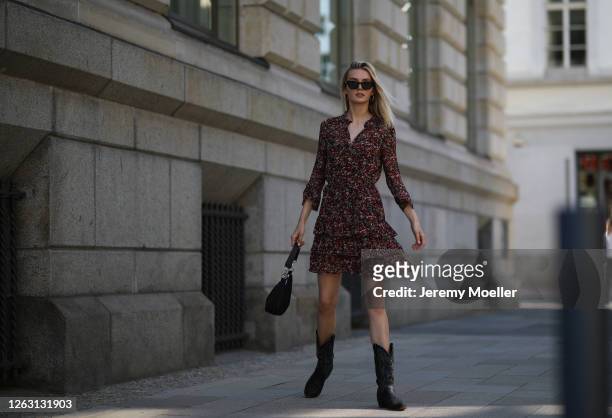 Eva Staudinger wearing SET Fashion dress and vintage cowboy boots on July 31, 2020 in Hamburg, Germany.