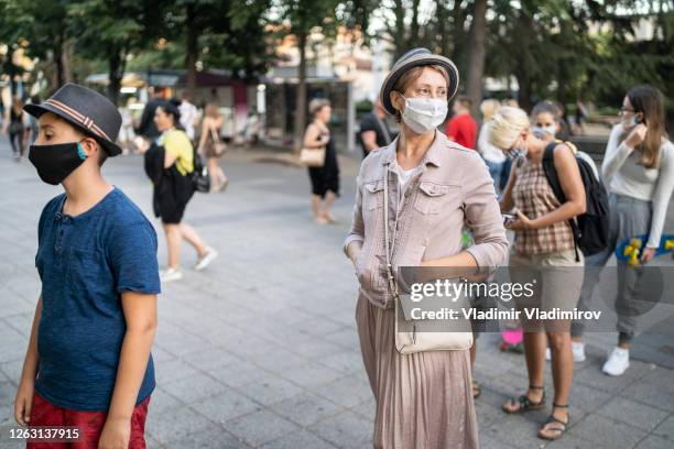 new normal: social distancing while waiting in line after covid-19 pandemic - 2020 mask stock pictures, royalty-free photos & images