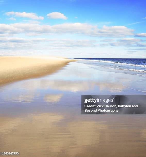 beautiful seascape and shoreline with clouds and reflections at jones beach, long island - jones beach stock-fotos und bilder